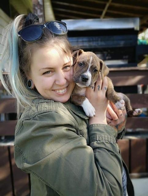 Jessi Mills holding a puppy