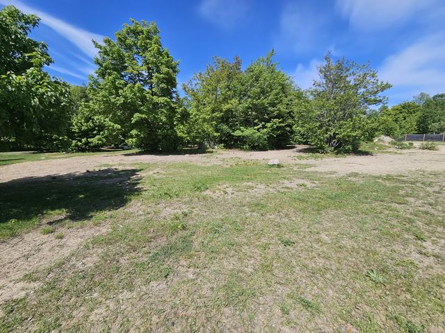 Open grassy field under a blue sky
